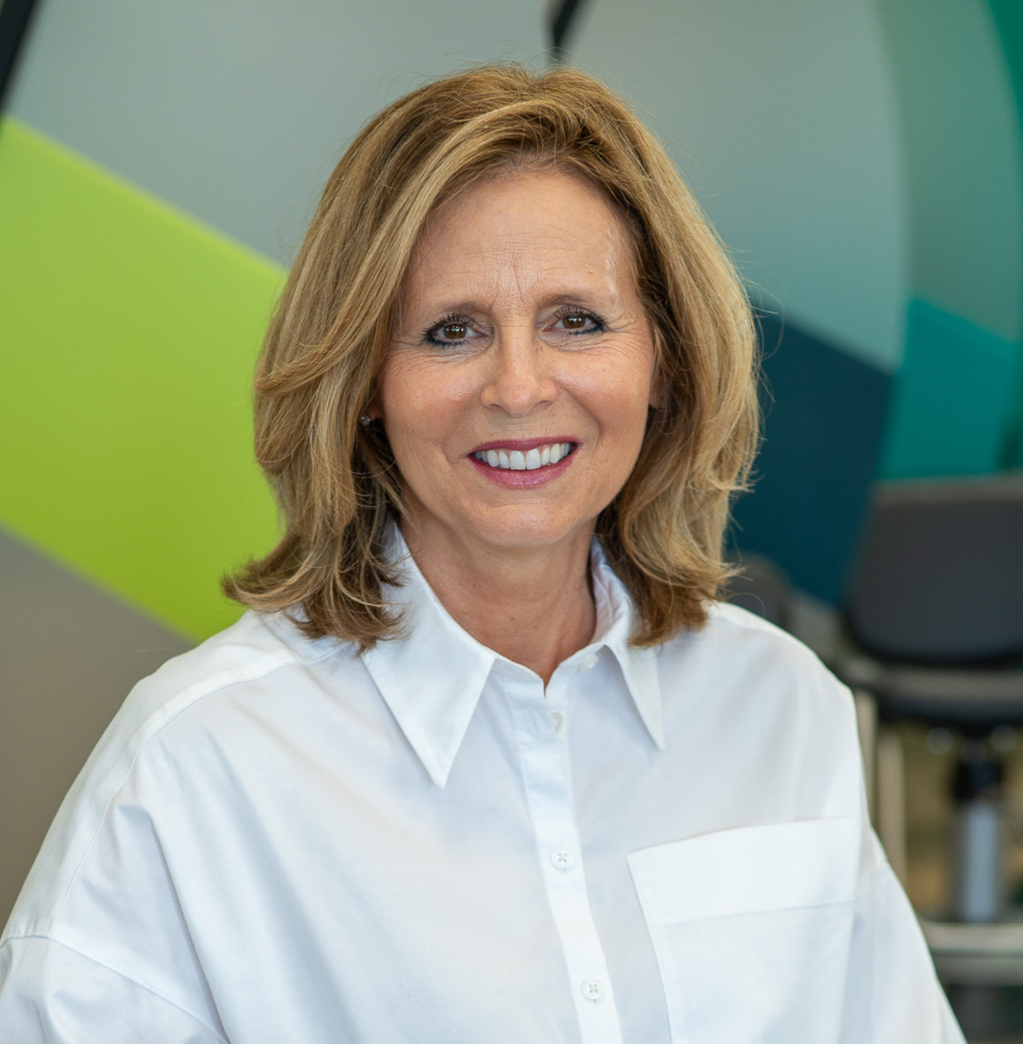 Sally Bell, owner of GCAZ Services and Arizona’s largest Great Clips franchise, seated in a salon.
